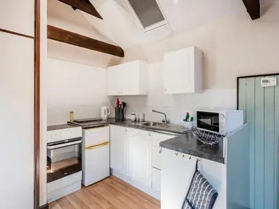 a kitchen with white cabinets and white appliances at Robin - Uk48171 in Colchester