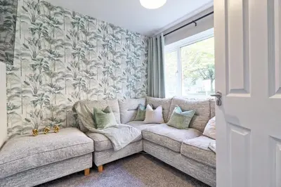 a living room with a couch and a window at Modern 5-Bed Property, Ideal for Extended Business & Contractor Stays in Colchester