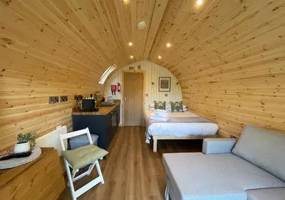 a room with two beds in a log cabin at Great Hallingbury Lodges in Hallingbury