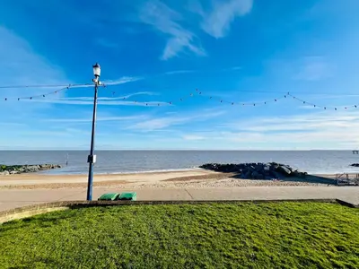 a bird sitting on top of a pole at the beach at Unique Apartment with Stunning Views 2B in Felixstowe