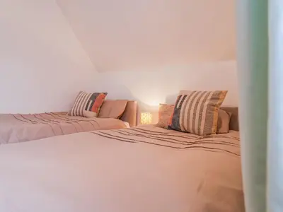 a living room with a bed and a couch at Brook Lodge in Ipswich