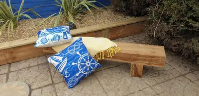 two ties sitting on top of a wooden bench at Rainbow on Sea Frinton-on-Sea in Kirby Cross