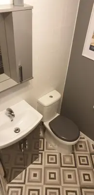 a bathroom with a toilet and a sink at Rainbow on Sea Frinton-on-Sea in Kirby Cross