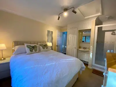 a bedroom with a large bed with a blue blanket at The Annex in Tostock