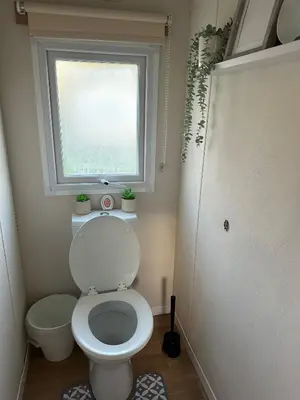 a bathroom with a white toilet and a window at Beatrice homes in Parkeston