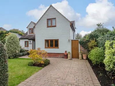 a white house with a brick driveway at Oakleaves in Colchester