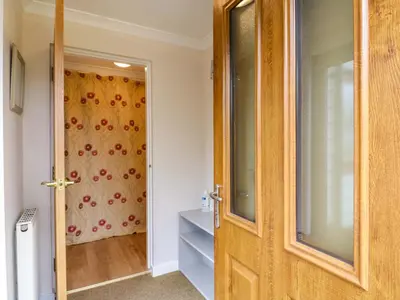 a wooden door in a room with a window at Oakleaves in Colchester