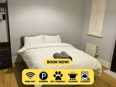 a bedroom with a bed with a sign that says book now at 4br 2bath Home In Colchester Perfect For Big Group in Mile End