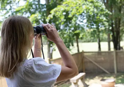 a woman taking a picture with a camera at Copper Beech Lodge with Hot Tub, Games Room, Fire Pit in Toppesfield