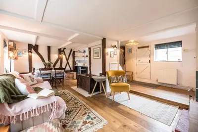 a living room with a couch and a table at Blythburgh Cottage, Yoxford in Yoxford