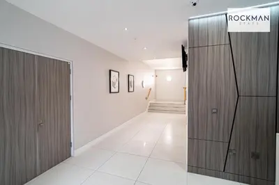 a hallway with a wooden door and a room at Library House Apartments - FREE PARKING - Contractor Hub - Superfast Wi-Fi - Long Term Stays in Brentwood
