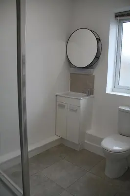 a bathroom with a toilet and a mirror on the wall at Colchester town and castle modern flat with kitchen & private parking in Hythe
