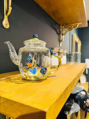a glass teapot sitting on top of a wooden table at The Green Scholar's Nook in Cambridge