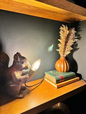a wooden rat sitting on a shelf reading a book at The Green Scholar's Nook in Cambridge