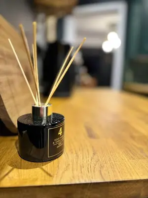 a black container with bamboo sticks in it on a table at The Green Scholar's Nook in Cambridge