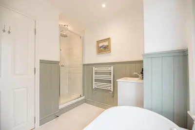 a bathroom with a shower and a toilet and a sink at Millicent Cottage, Aldeburgh in Aldeburgh