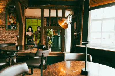 a dining room with a table and chairs at The George in Cavendish