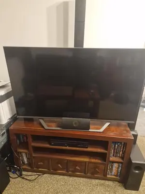 a flat screen tv on a wooden entertainment center at Lovely One bedroom flat with free off road parking in Norton