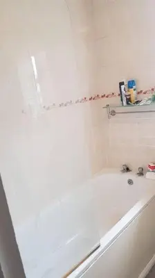 a white bathroom with a tub and a sink at Lovely One bedroom flat with free off road parking in Norton