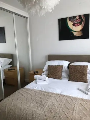 a bedroom with a bed and a painting on the wall at Modern house close to amenities St Ives Cambs in St Ives