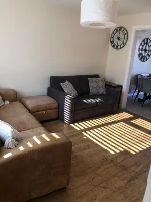 a living room with a couch and a table at Modern house close to amenities St Ives Cambs in St Ives