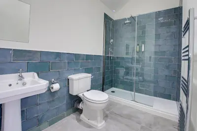 a bathroom with a toilet and a sink and a shower at The Kings Arms Rooms in Saint Osyth