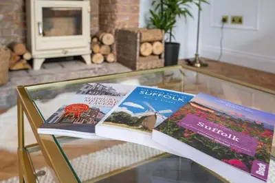 two books sitting on top of a glass table at Victoria Cottage in Monks Eleigh