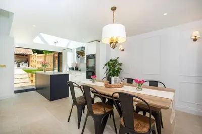a kitchen with a dining room table and chairs at Victoria Cottage in Monks Eleigh