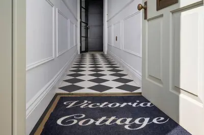 a hallway with a black and white checkered floor at Victoria Cottage in Monks Eleigh