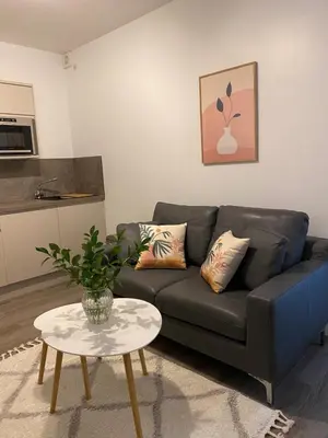 a living room with a couch and a table at Dream Yard Apartments in Southend-on-Sea