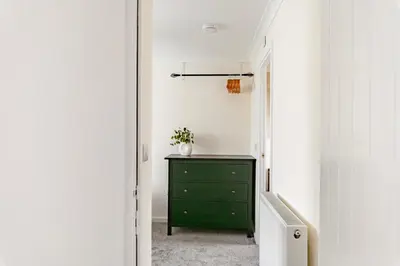 a green dresser in a hallway with a green cabinet at Comfortable 4-Bedroom Heaven in Thetford in Thetford