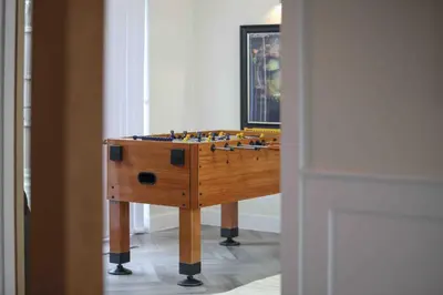 a wooden table with a board game on it at Kestrel Gardens Five Bedroom Homes in Great Dunmow