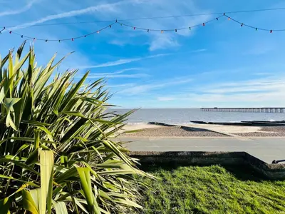 a view of the beach with a pier in the background at Stunning 2 bedroom flat for 5 people overlooking the sea 2A in Felixstowe