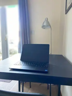 a laptop computer sitting on top of a desk at One Bedroom Bungalow No1 - Secure Gated Parking in Basildon