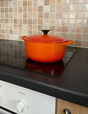 an orange pot sitting on top of a stove at One Bedroom Bungalow No1 - Secure Gated Parking in Basildon