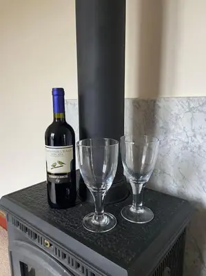 a bottle of wine and two wine glasses on a table at One Bedroom Bungalow No1 - Secure Gated Parking in Basildon