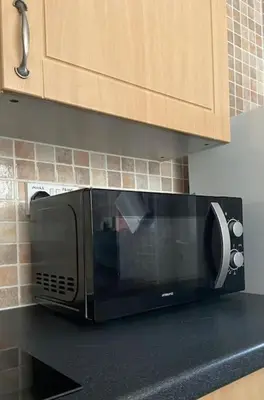 a microwave on a counter in a kitchen at One Bedroom Bungalow No1 - Secure Gated Parking in Basildon