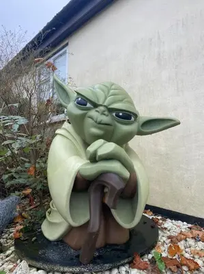 a statue of the baby yoda sitting on the ground at One Bedroom Bungalow No1 - Secure Gated Parking in Basildon