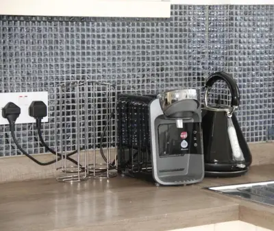 a kitchen counter with a coffee maker and a toaster at No 13 Colchester Town Flat with Kitchen & Parking in Colchester