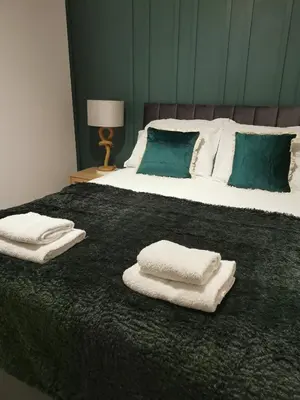 a bedroom with two white towels on a bed at No 13 Colchester Town Flat with Kitchen & Parking in Colchester