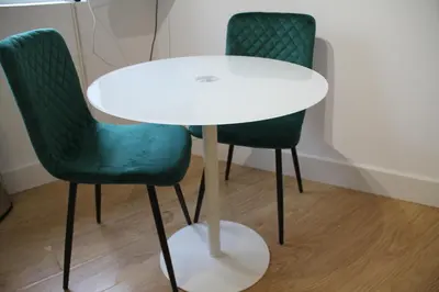 a white table and two green chairs in a room at No 13 Colchester Town Flat with Kitchen & Parking in Colchester