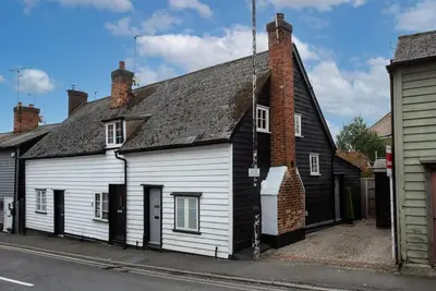 an old white and black house on a street at Norsey Cottage Billericay in Billericay