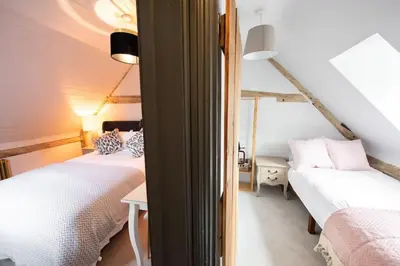 a bedroom with two beds in a room at Norsey Cottage Billericay in Billericay