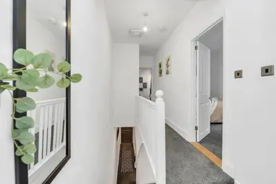 a hallway of a house with white walls and a plant at Wherstead Rd House By Homestyles Hosts Short Lets & Serviced Accommodation Suffolk With Free Parking in Ipswich
