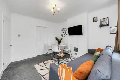 a living room with a couch and a table at Wherstead Rd House By Homestyles Hosts Short Lets & Serviced Accommodation Suffolk With Free Parking in Ipswich