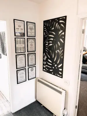 a room with a radiator and pictures on the wall at Comfortable 2-Bed Home, Perfect for Work and Leisure in Colchester in Colchester