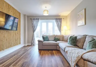 a living room with a couch and a tv at Well-Located 4 Bed Property in Colchester, Suited for Families and Business Travelers in Colchester