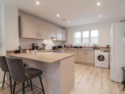 a kitchen with a counter and a washer and dryer at Inishnee House in Ipswich