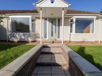 a house with a walkway in front of a yard at Farmer's Rest in Ely