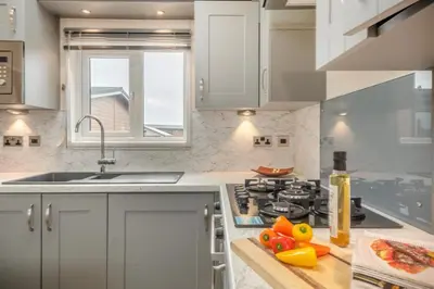 a kitchen with a stove and a sink and a window at 2 Bed in Welney oc-c30124 in Welney